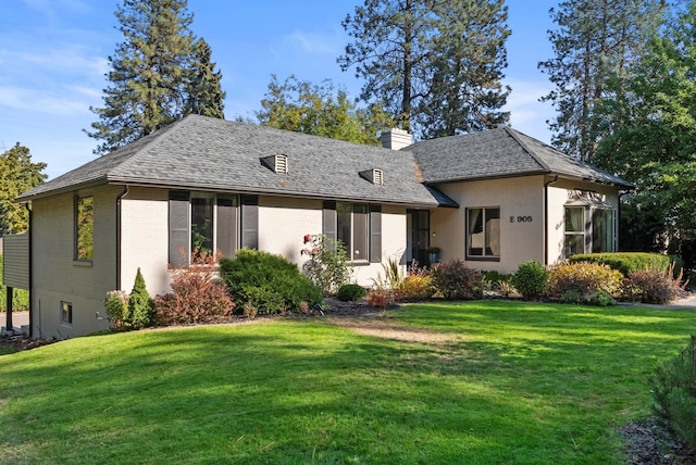 rear view of property with a lawn