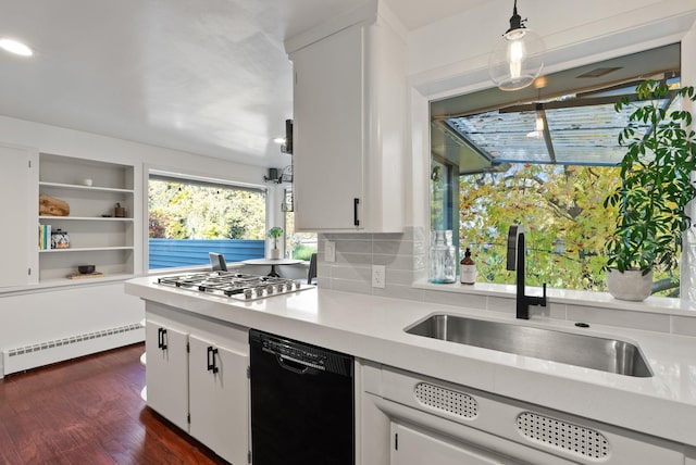 kitchen with dishwasher, decorative light fixtures, and white cabinetry