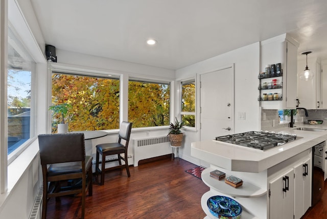 kitchen featuring white cabinetry, sink, pendant lighting, and stainless steel gas cooktop