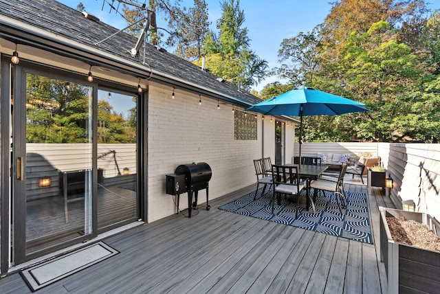 wooden deck with a grill