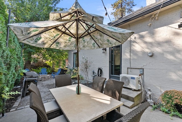 view of patio / terrace with a grill, ac unit, and a fire pit