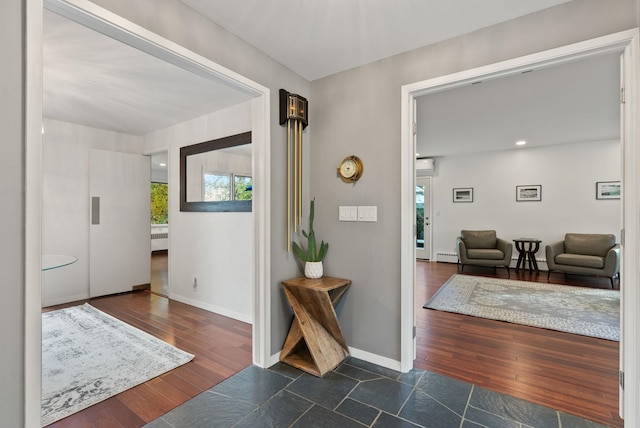 foyer entrance with a baseboard heating unit