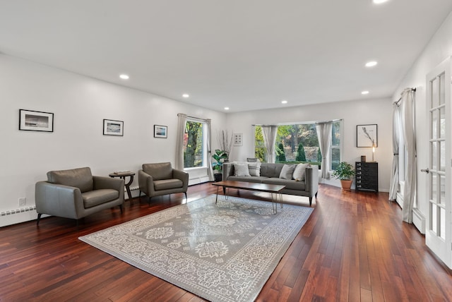 living room featuring dark hardwood / wood-style floors and a baseboard radiator