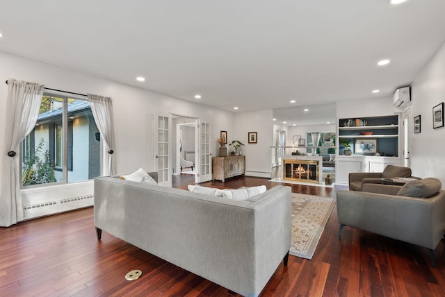 living room featuring dark hardwood / wood-style flooring, an AC wall unit, french doors, and a baseboard radiator