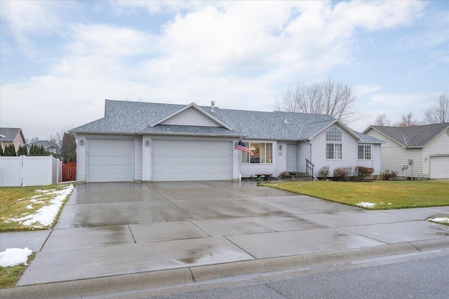 ranch-style house featuring a garage and a front yard