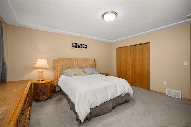 carpeted bedroom featuring a closet