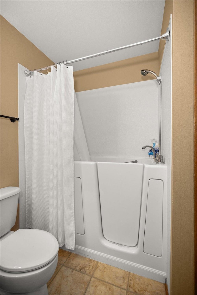 bathroom with tile patterned floors and toilet