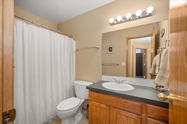 bathroom featuring tile patterned floors, vanity, and toilet