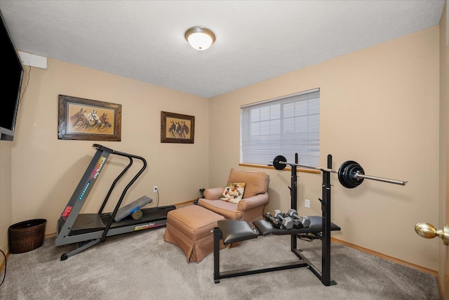 workout room featuring light carpet