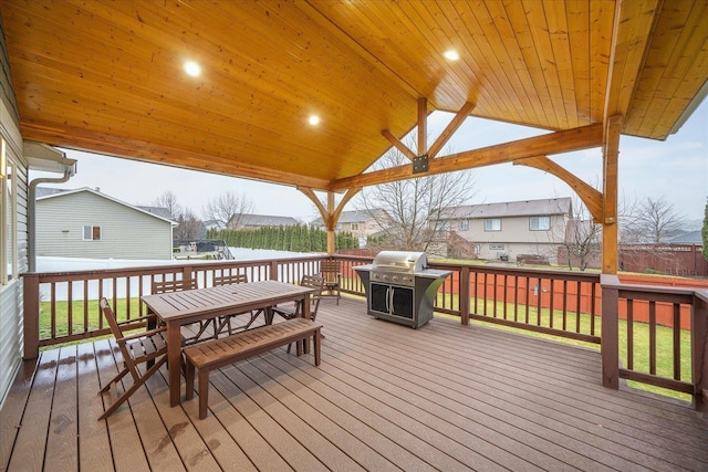 wooden deck featuring a lawn and area for grilling