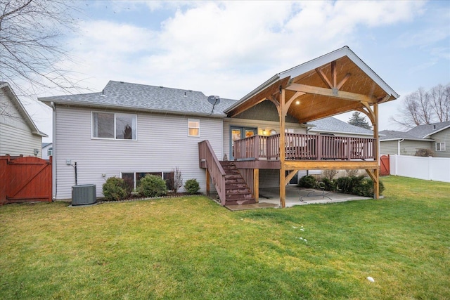 back of property featuring a lawn, a patio area, a deck, and central air condition unit