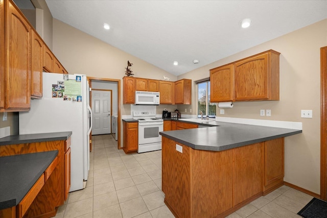 kitchen featuring lofted ceiling, white appliances, sink, light tile patterned floors, and kitchen peninsula