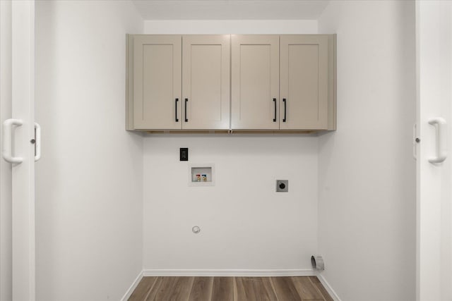 washroom with cabinets, electric dryer hookup, hookup for a gas dryer, dark hardwood / wood-style flooring, and hookup for a washing machine