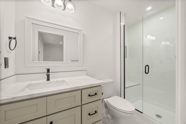 bathroom featuring vanity, toilet, and walk in shower