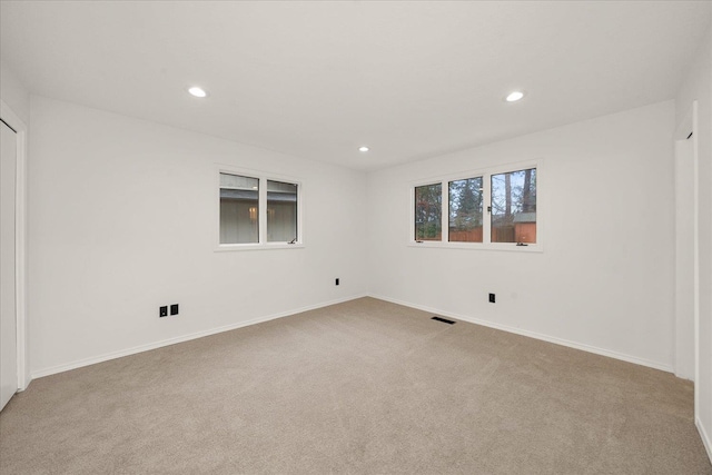 spare room with light colored carpet