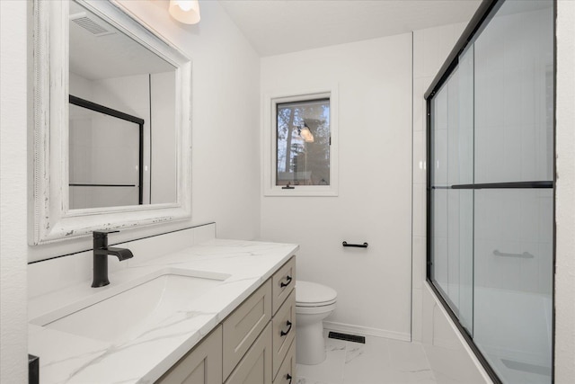 full bathroom featuring vanity, toilet, and shower / bath combination with glass door