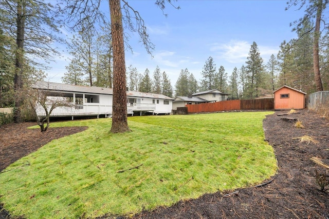 view of yard with a storage unit and a wooden deck