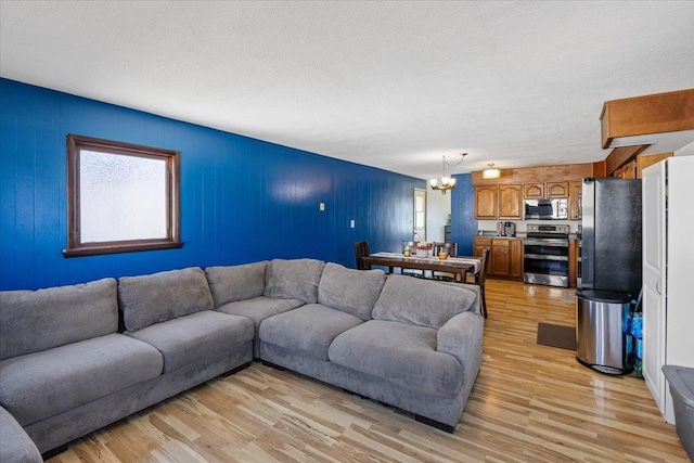 living room featuring light hardwood / wood-style floors and a notable chandelier