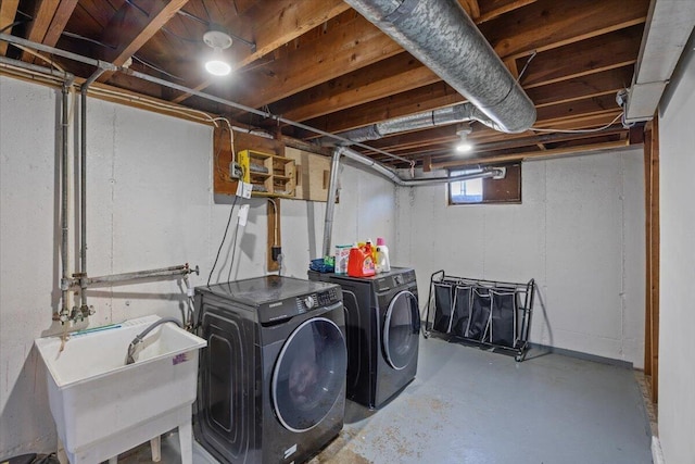 washroom featuring washing machine and dryer and sink