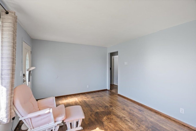 sitting room with dark wood-type flooring