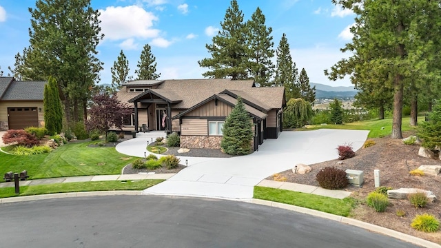 craftsman house with a mountain view and a front lawn