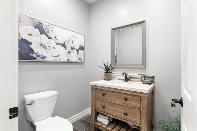 bathroom featuring tile patterned floors, vanity, and toilet