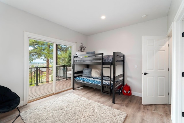 bedroom featuring access to exterior and hardwood / wood-style flooring