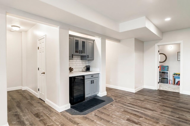 bar with gray cabinetry, dark hardwood / wood-style floors, wine cooler, and tasteful backsplash