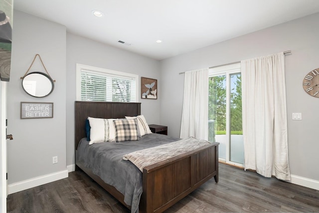 bedroom with access to outside, multiple windows, and dark hardwood / wood-style flooring