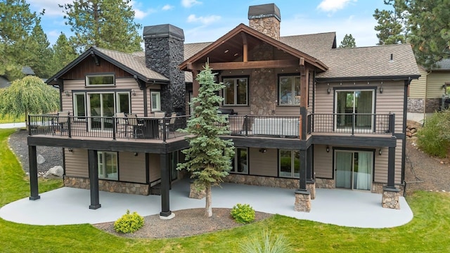 rear view of property with a lawn and a patio area