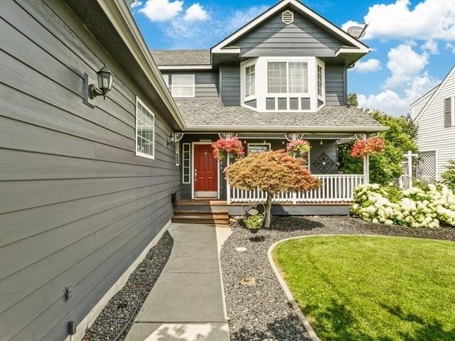 entrance to property featuring a yard