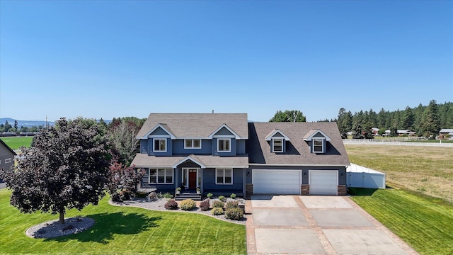 view of front of house with a front yard and a garage