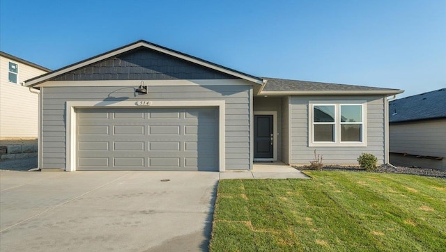 ranch-style house featuring a front yard and a garage