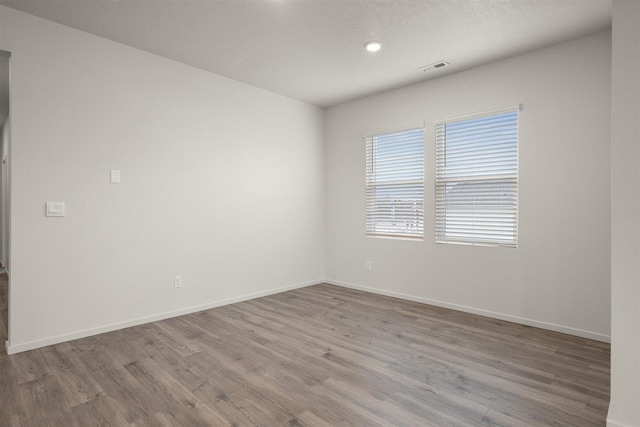 unfurnished room featuring light hardwood / wood-style floors