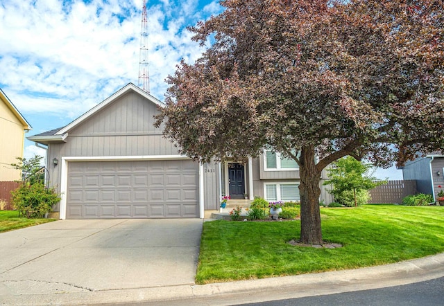 view of front of home with a garage and a front lawn