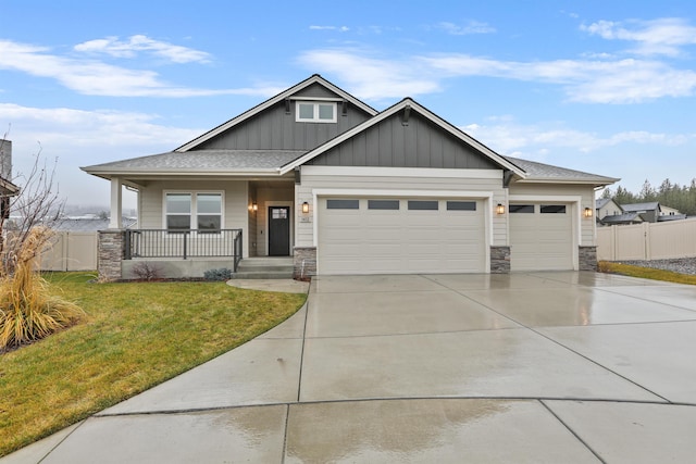 craftsman inspired home featuring a front lawn, covered porch, and a garage