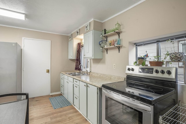 kitchen with white cabinetry, sink, crown molding, appliances with stainless steel finishes, and light wood-type flooring