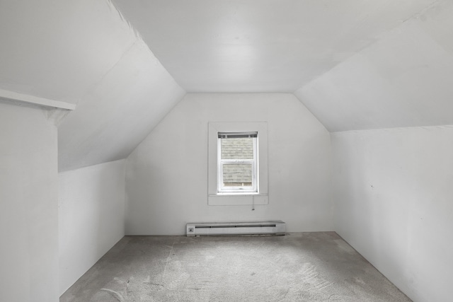 additional living space featuring carpet flooring, lofted ceiling, and a baseboard heating unit