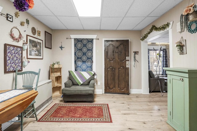 foyer featuring a drop ceiling and light hardwood / wood-style floors