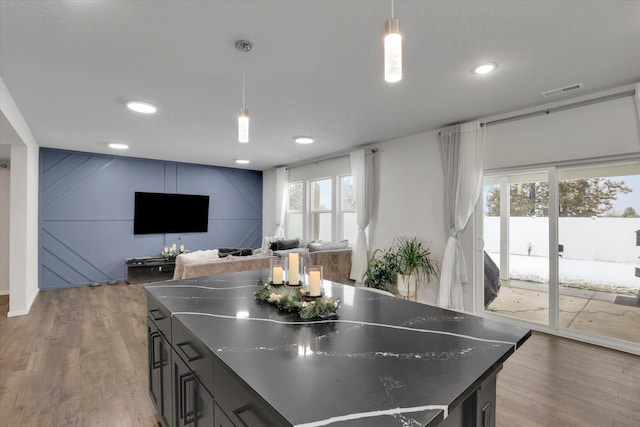 kitchen with pendant lighting and wood-type flooring