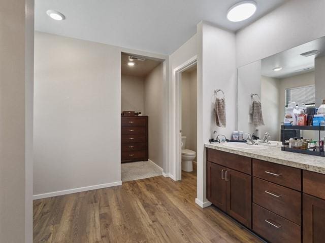 bathroom featuring hardwood / wood-style floors, vanity, and toilet