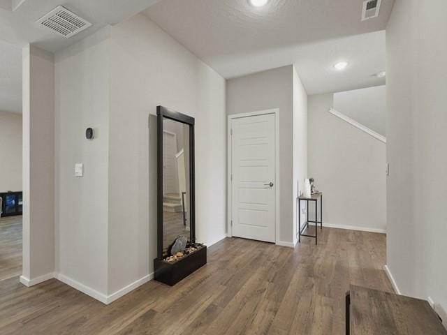 corridor with wood-type flooring