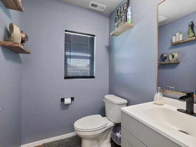 bathroom featuring vanity and toilet