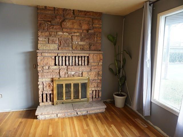 interior space with a fireplace and hardwood / wood-style flooring