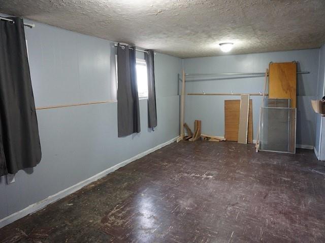 spare room with a textured ceiling