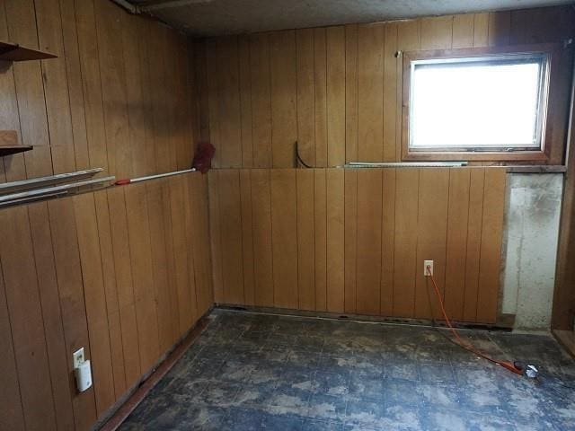 spare room with wood walls