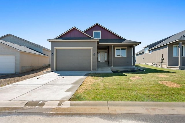 view of front of property with a front yard and a garage