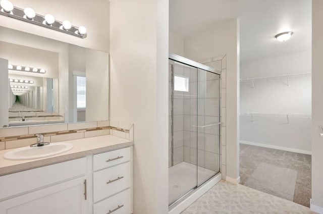 bathroom featuring backsplash, plenty of natural light, vanity, and walk in shower