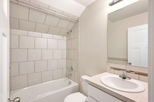 full bathroom with tasteful backsplash, vanity, vaulted ceiling, toilet, and tiled shower / bath