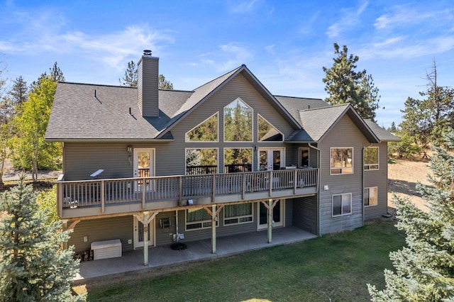 back of house featuring a wooden deck, a yard, and a patio